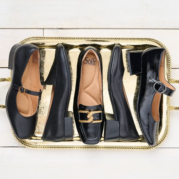 Featuring the Elsey, Eldyn, Erica, Lillian and Laura pumps in various colors of black in a group laying on a gold platter.